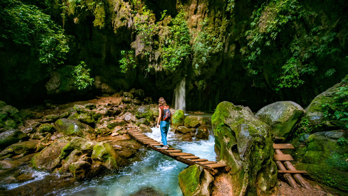 Woman crossing bridge