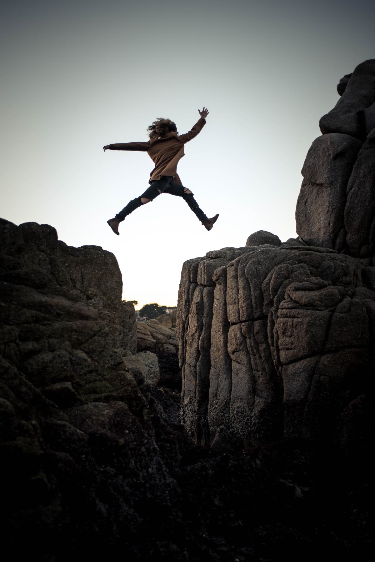 Individual jumping from a rock